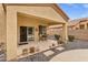 Covered patio with outdoor seating area, decorative plants, and access to the landscaped backyard at 2280 E Aloe Pl, Chandler, AZ 85286