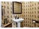 Stylish powder room features a pedestal sink and unique wallpaper at 2280 E Aloe Pl, Chandler, AZ 85286