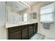Bathroom featuring a double sink vanity, mirror and natural light at 2315 N 73Rd Dr, Phoenix, AZ 85035