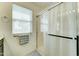 Bright bathroom featuring a glass enclosed shower, window, neutral colors and modern finishes at 2315 N 73Rd Dr, Phoenix, AZ 85035