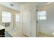 Well-lit bathroom featuring a glass-enclosed shower and separate toilet room at 2315 N 73Rd Dr, Phoenix, AZ 85035