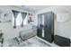 Comfortable bedroom with a chaise lounge, modern decor, and black wardrobe with mirrored doors at 2315 N 73Rd Dr, Phoenix, AZ 85035