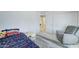 Well-lit bedroom shows a bed, gray recliner, closet, and neutral carpet at 2315 N 73Rd Dr, Phoenix, AZ 85035