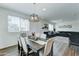 Bright dining area with an elegant chandelier, a dining table with seating for six, and an open floor plan at 2315 N 73Rd Dr, Phoenix, AZ 85035