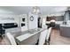 Open dining room with dark wood table, linen chairs, stylish centerpiece, and views of the kitchen and living room at 2315 N 73Rd Dr, Phoenix, AZ 85035