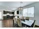 Bright dining area with a dark wood table, upholstered chairs, and a view of the kitchen with modern appliances at 2315 N 73Rd Dr, Phoenix, AZ 85035