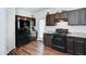 This kitchen features dark wood cabinets, stainless steel appliances, wood floors and plenty of storage space at 2315 N 73Rd Dr, Phoenix, AZ 85035