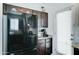 This kitchen has dark wood cabinets, stainless steel appliances, granite countertops, wood floors and a door to the outside at 2315 N 73Rd Dr, Phoenix, AZ 85035