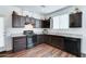 Well-lit kitchen with dark wood cabinets, stainless steel appliances, granite countertops and wood floors at 2315 N 73Rd Dr, Phoenix, AZ 85035