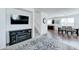 Open-concept living area showcasing a fireplace, staircase, and views of the dining area and kitchen at 2315 N 73Rd Dr, Phoenix, AZ 85035