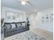 Bright living room with gray sofa, decorative pillows, neutral carpet, and stylish mirror at 2315 N 73Rd Dr, Phoenix, AZ 85035