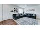 Comfortable living room with an oversized sectional couch, patterned area rug, and plenty of natural light at 2315 N 73Rd Dr, Phoenix, AZ 85035