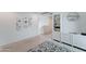Bright, carpeted living room featuring white shelving and contemporary floral artwork at 2315 N 73Rd Dr, Phoenix, AZ 85035