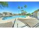 Community pool with desert landscaping and several tall palm trees for shade at 2315 N 73Rd Dr, Phoenix, AZ 85035