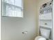 Bathroom with a toilet and built in shelving unit at 2315 N 73Rd Dr, Phoenix, AZ 85035