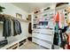Organized walk-in closet with clothing racks, shelving, drawers, and ample storage space at 2315 N 73Rd Dr, Phoenix, AZ 85035