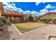 Backyard featuring gravel, a grassy area, a covered patio, and desert landscaping surrounding the home at 26015 S Grapefruit Dr, Queen Creek, AZ 85142