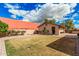 An outdoor living space featuring a detached garage with a fire pit, gravel and views of blue skies at 26015 S Grapefruit Dr, Queen Creek, AZ 85142
