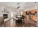 Open concept dining room featuring fireplace and spacious kitchen with stainless appliances at 26015 S Grapefruit Dr, Queen Creek, AZ 85142