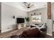 Inviting living room showcasing wood floors, a large TV, and stylish decor at 26015 S Grapefruit Dr, Queen Creek, AZ 85142
