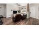 Cozy living room featuring wood flooring, a ceiling fan, and comfortable seating at 26015 S Grapefruit Dr, Queen Creek, AZ 85142