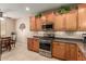 Well-equipped kitchen featuring stainless steel appliances, wood cabinets, and tiled backsplash at 30444 N Bismark St, San Tan Valley, AZ 85143