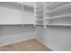 Organized walk-in closet with shelving and racks, providing ample storage space at 40335 W Novak Ln, Maricopa, AZ 85138