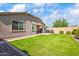 Lush backyard with green grass, a block wall for privacy, and an open patio space at 4121 W Bradshaw Creek Ln, New River, AZ 85087