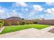 Expansive backyard featuring a well-maintained lawn, privacy wall, and paved patio at 4121 W Bradshaw Creek Ln, New River, AZ 85087