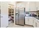 Bright kitchen features stainless steel refrigerator and walk-in pantry with ample shelving at 4121 W Bradshaw Creek Ln, New River, AZ 85087