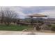 Community playground with a covered play structure, a picnic area, grassy field and mountain views at 4121 W Bradshaw Creek Ln, New River, AZ 85087