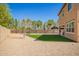 Large backyard with an artificial turf lawn and a gravel area with a dining set at 41734 N Cielito Linda Way, San Tan Valley, AZ 85140