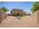 Spacious backyard with gravel, green grass, seating, and a fire pit at 41734 N Cielito Linda Way, San Tan Valley, AZ 85140