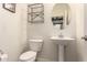Powder room featuring toilet and pedestal sink with framed mirror above at 41734 N Cielito Linda Way, San Tan Valley, AZ 85140