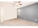 A spacious bedroom with carpet, a ceiling fan, and a window providing natural light at 41734 N Cielito Linda Way, San Tan Valley, AZ 85140