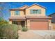 Two-story home with a brown two-car garage, desert landscaping and a brown roof at 41734 N Cielito Linda Way, San Tan Valley, AZ 85140