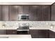 Close up of kitchen features including stainless steel appliances and decorative tile backsplash at 41734 N Cielito Linda Way, San Tan Valley, AZ 85140
