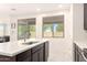 Kitchen island with stainless steel sink and faucet, white countertop, and backyard views at 41734 N Cielito Linda Way, San Tan Valley, AZ 85140