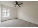 A comfortable bedroom with neutral carpeting and a modern ceiling fan at 4545 N 67Th Ave # 1106, Phoenix, AZ 85033