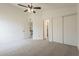 This cozy bedroom provides ample space with neutral carpeting and access to closets and bathrooms at 4545 N 67Th Ave # 1106, Phoenix, AZ 85033