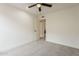 Bedroom with neutral-colored carpeting, access to another room, and modern ceiling fan at 4545 N 67Th Ave # 1106, Phoenix, AZ 85033