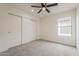 Spacious bedroom featuring soft carpeting, a window, and a closet at 4545 N 67Th Ave # 1106, Phoenix, AZ 85033
