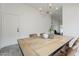 Dining area featuring a rustic table and modern lighting at 4545 N 67Th Ave # 1106, Phoenix, AZ 85033