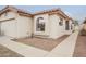 Exterior side view of a beige single-story home with desert landscaping and a tiled roof at 4545 N 67Th Ave # 1106, Phoenix, AZ 85033