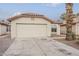 Home exterior featuring a tile roof, a two-car garage, and desert landscaping at 4545 N 67Th Ave # 1106, Phoenix, AZ 85033