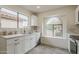 Renovated kitchen boasts white cabinets, marble backsplash, wood-look floors and modern appliances at 4545 N 67Th Ave # 1106, Phoenix, AZ 85033