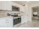 This updated kitchen has white cabinets, stainless appliances, marble backsplash and wood-look floors at 4545 N 67Th Ave # 1106, Phoenix, AZ 85033