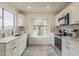 Updated kitchen with marble backsplash, sleek appliances, arched window, and wood-look flooring at 4545 N 67Th Ave # 1106, Phoenix, AZ 85033