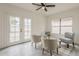 Bright living room features French doors, light gray chairs, and luxury wood-look vinyl plank flooring at 4545 N 67Th Ave # 1106, Phoenix, AZ 85033