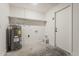 Utility room featuring a water heater, shelving, and access to the outside at 4545 N 67Th Ave # 1106, Phoenix, AZ 85033
